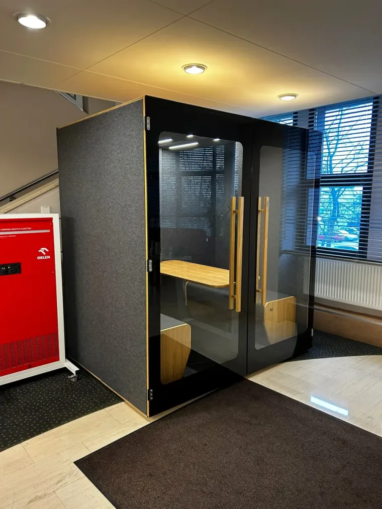 HIDE H4 acoustic booth in an Orlen office lobby, next to a red branded vending machine