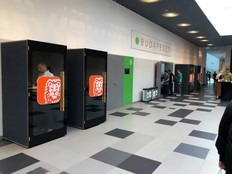 A row of black HIDE H1 acoustic booths with the ING Bank logo at a trade event in Budapest
