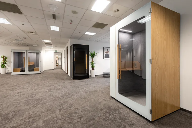 HIDE H1+ booth with a wood panel in a showroom setting with several other booth models
