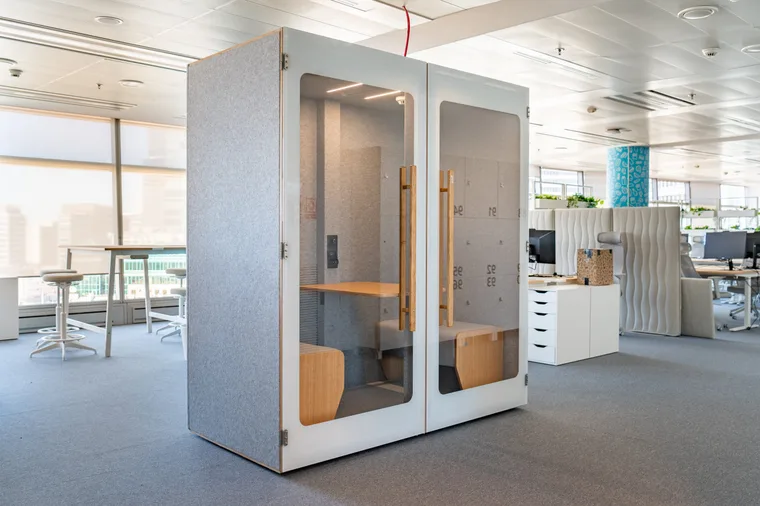 Light HIDE H2 acoustic booth with a numbered interior pattern, surrounded by open-plan desks